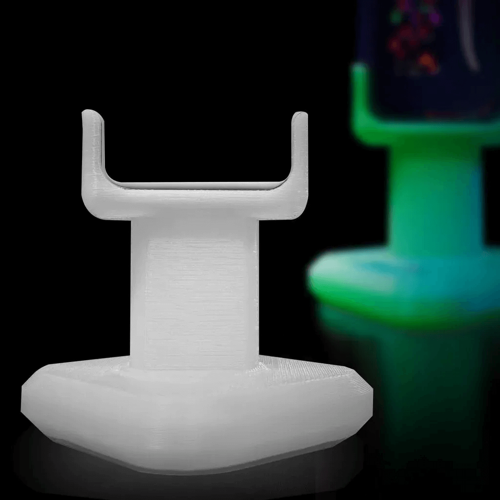 Genius “Lit” Stand shown with second glowing version in background.