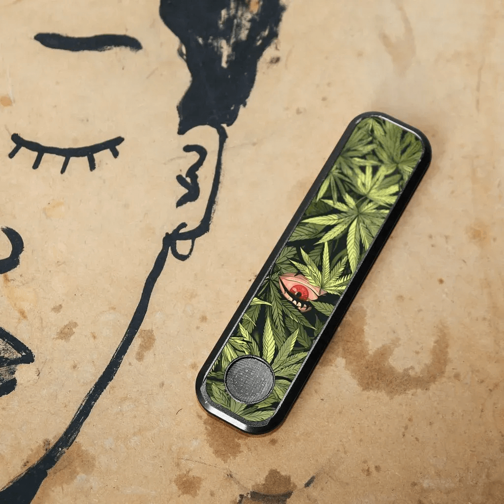 Genius Pipe β The Plant and I edition resting on an artistic sketch of a face.