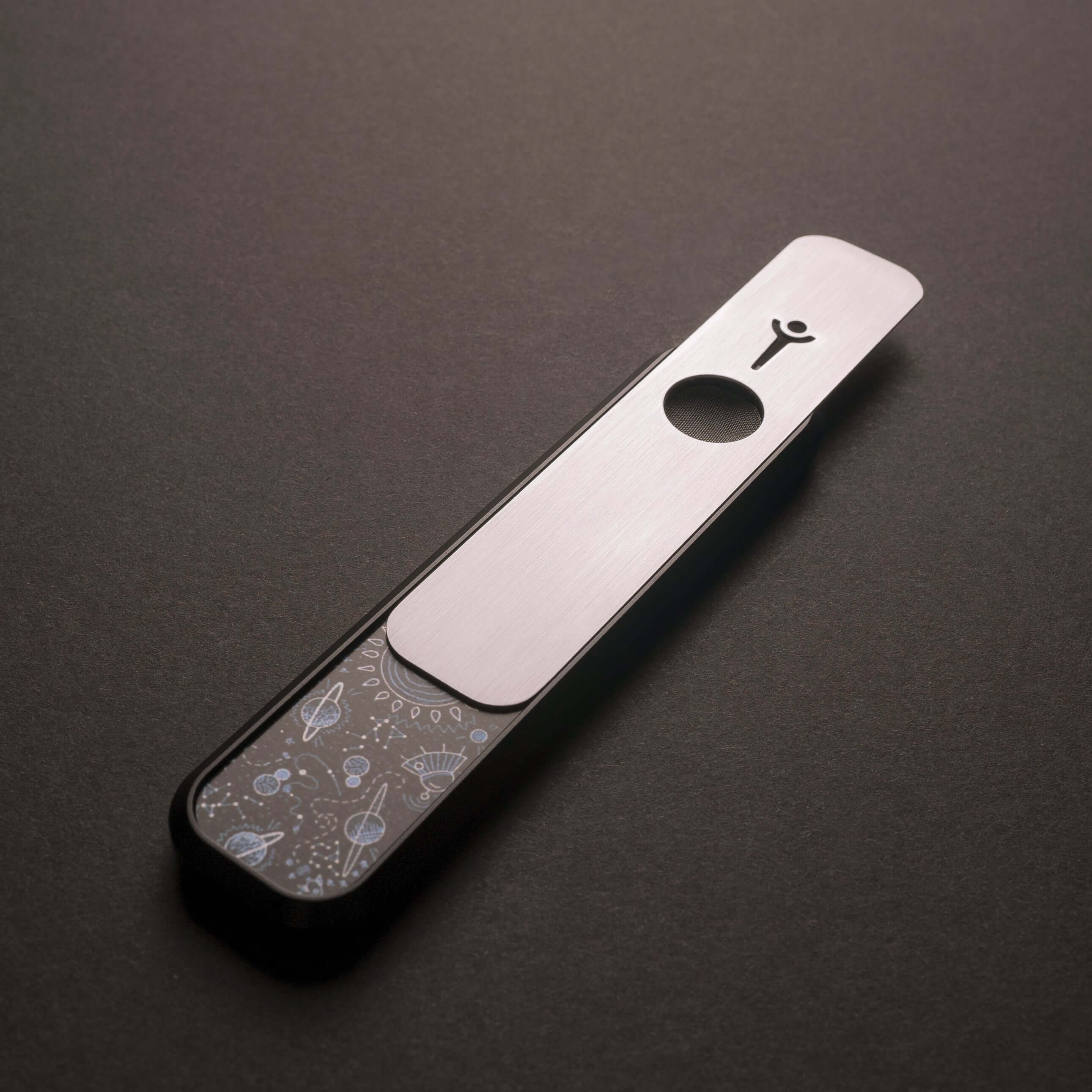 Genius Pipe – Through The Universe edition with slider open, exposing bowl – felt background.
